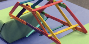 This is a stem activity using popsicle sticks to make a bridge